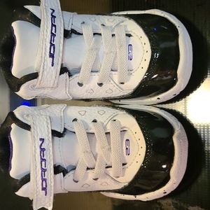 Size 4C Baby Black, white, and Purple Jordan shoes